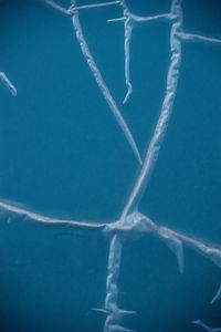 An abstract image showcasing intricate cracked ice patterns on a blue surface. Abstract deep‑blue fractured structure representing Paradise governance architecture after collapse.