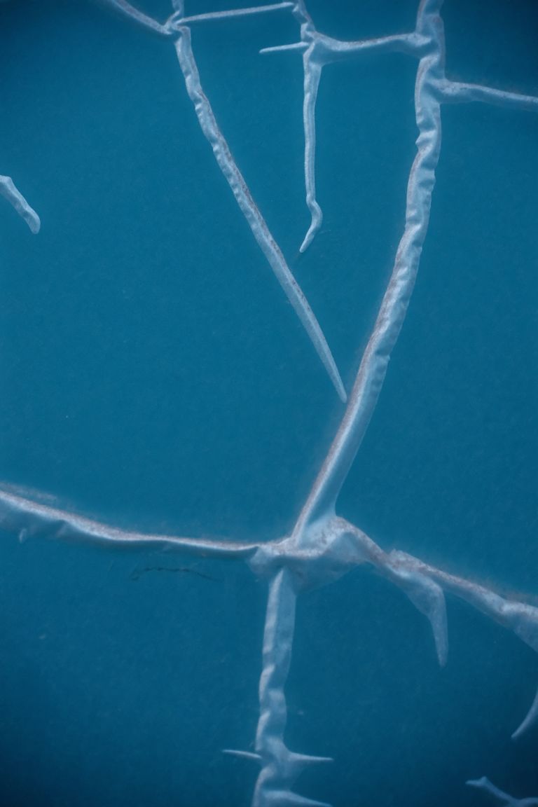 An abstract image showcasing intricate cracked ice patterns on a blue surface. Abstract deep‑blue fractured structure representing Paradise governance architecture after collapse.