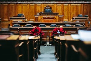 Spacious and elegant wooden courtroom with empty seats, located in Bern, Switzerland. Indian Energy autonomy- Governance signals 3
